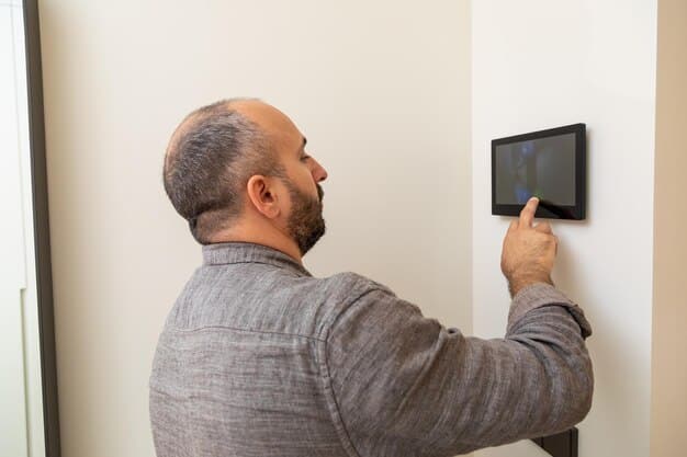 A close-up of a smart sprinkler controller installed on a garage wall, displaying a user-friendly interface with weather data and watering schedules. Various wires and connections are visible, illustrating the integration process.