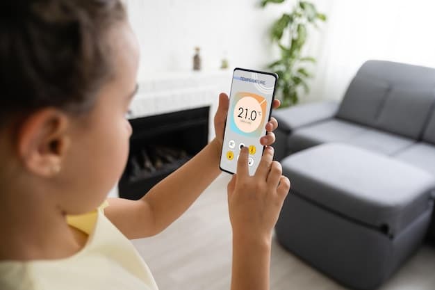 A person holding a smartphone displaying the interface of a smart thermostat app, showing temperature settings and energy usage data. The background is a modern living room.