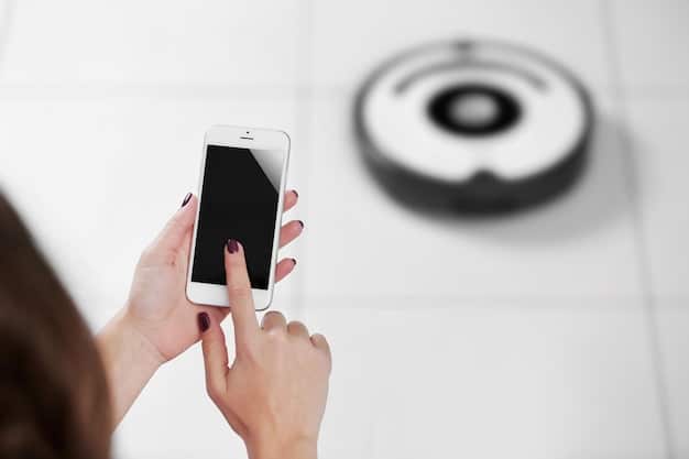 A close-up of a smartphone displaying a notification from a smart smoke detector app, showing a smoke or fire alert with the location in the house.