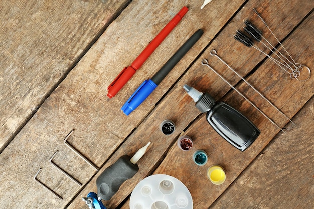 A collection of tools and materials neatly laid out on a workbench. Includes screwdrivers, wire strippers, a drill, wire connectors, and mounting screws. The smart video doorbell packaging is visible in the background.