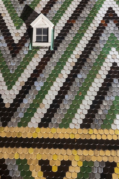 A close-up of various roofing materials including reflective shingles, tiles, and coatings, showcasing their textures and reflective properties under direct sunlight.