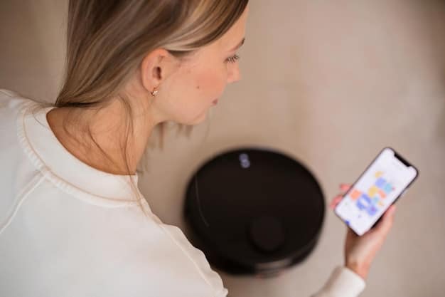 A close-up of a smart leak detector sensor touching a small puddle of water on a bathroom floor, with a smartphone displaying a notification about the detected leak.