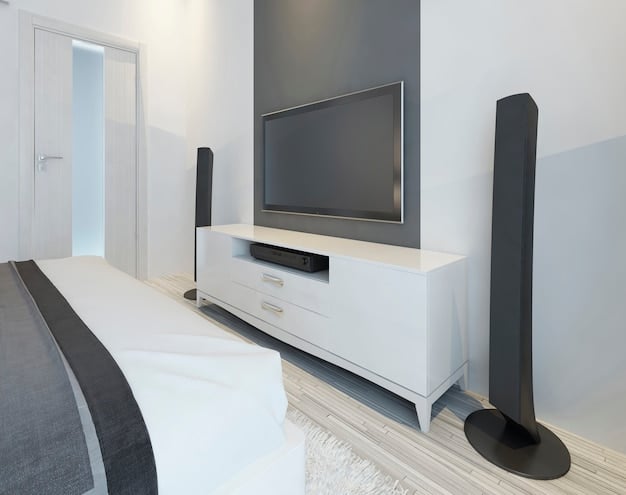 A sleek soundbar placed under a wall-mounted smart TV, showcasing its minimalist design and integration with the living room decor.