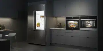 Modern kitchen with smart refrigerator and oven displaying integrated technology.